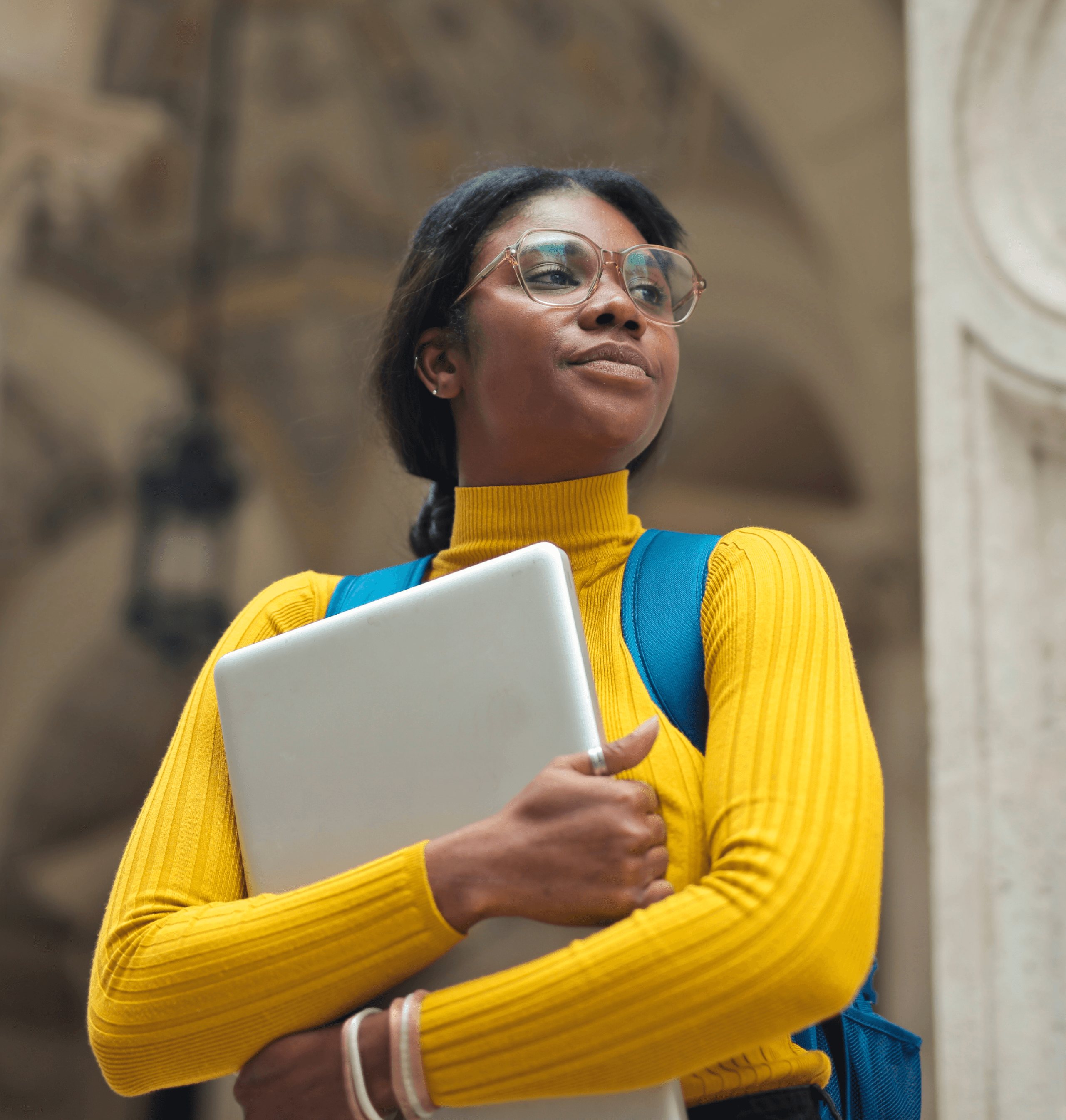 Young woman with laptop outside school